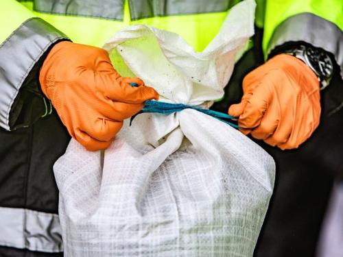 Firefighter tying a sandbag
